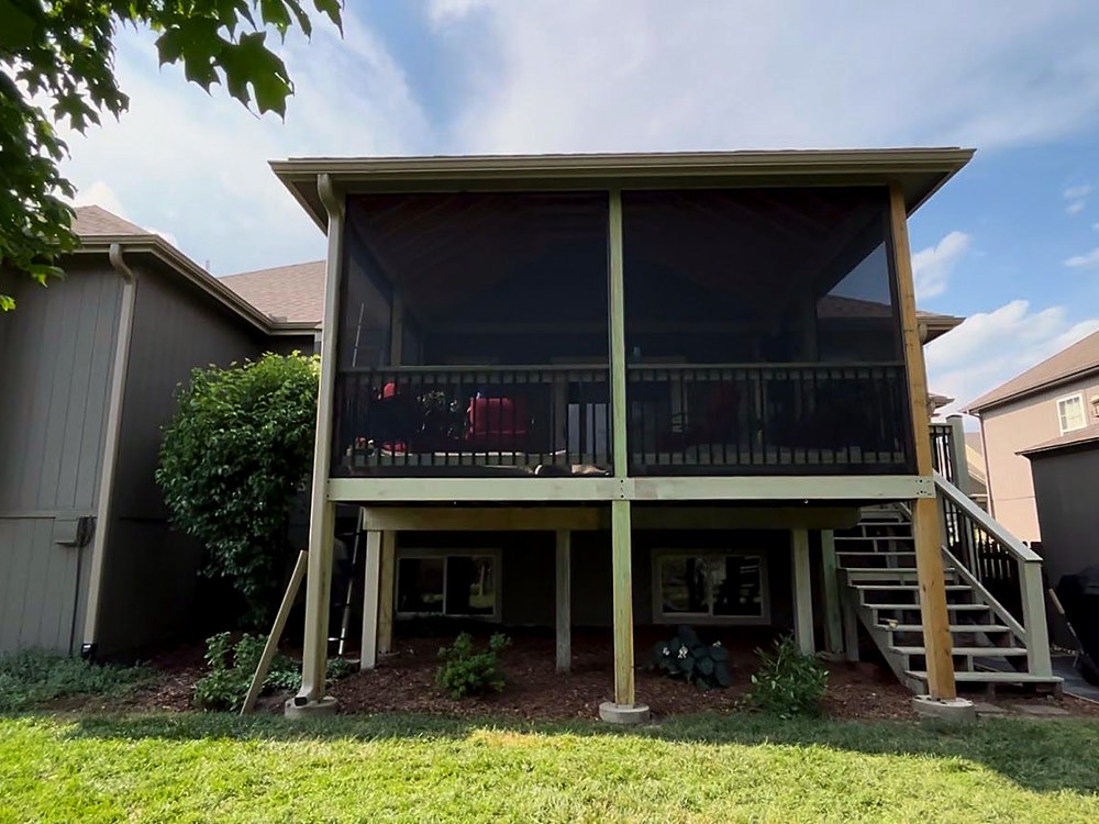 The completed screened-in porch on the rear of the house.